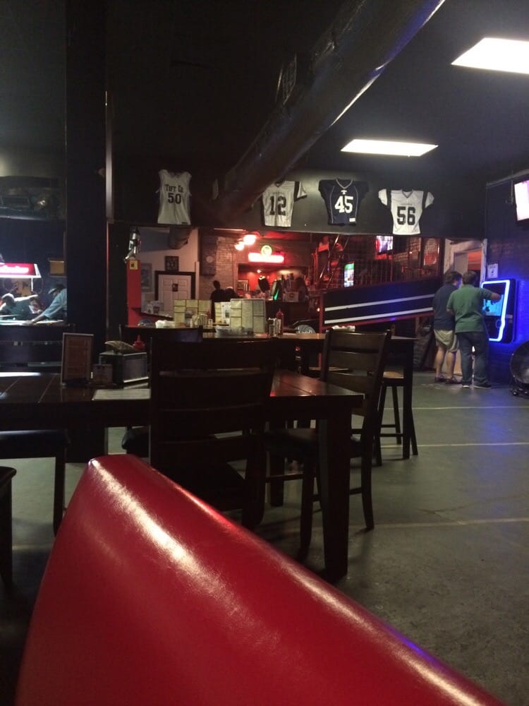 Wing Addiction main dining area with comfortable seating and sports screens in Tifton, Georgia